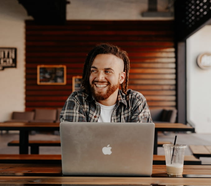 man smiling on his laptop